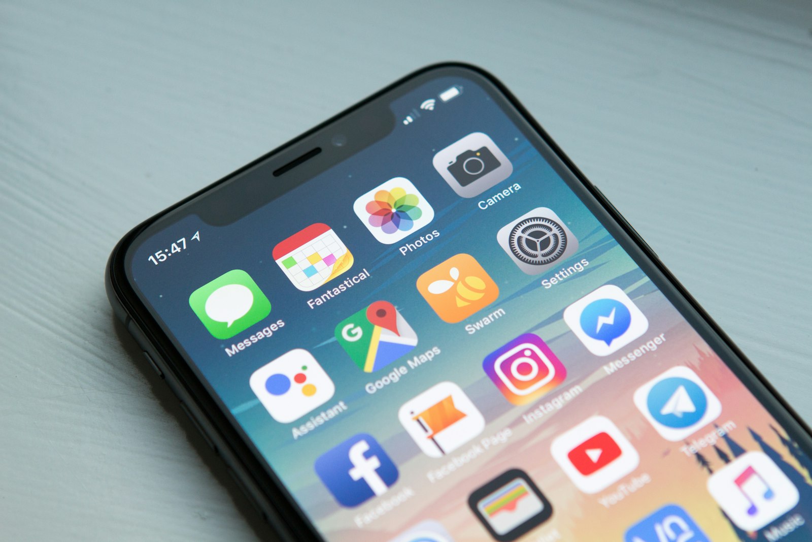 A person holding a phone showing a photo feed